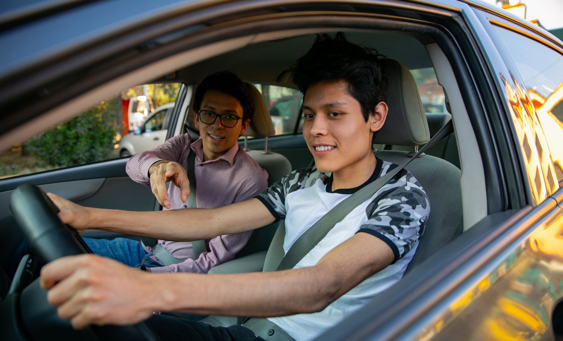 Learning to drive. Two young men in a driving session